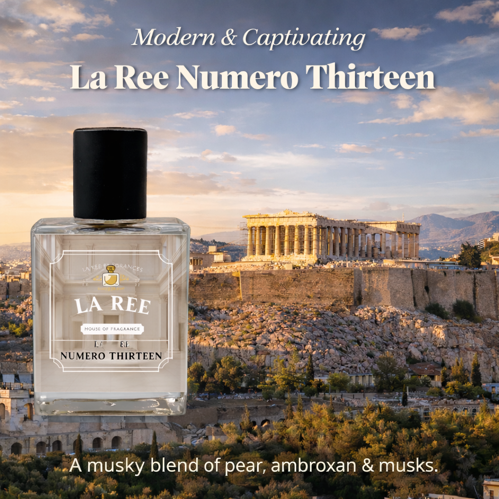 A bottle of La Ree Numero Thirteen perfume is shown in front of a scenic background of the Parthenon in Athens at sunset. The text reads 'Modern & Captivating La Ree Numero Thirteen' and 'A musky blend of pear, ambroxan & musks.